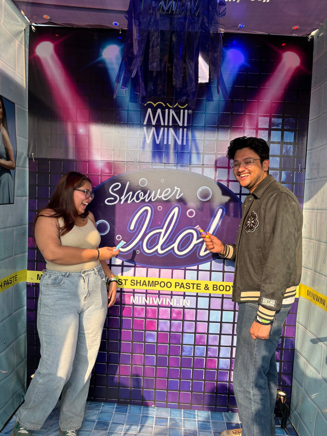 Festival attendee singing at MINIWINI Shower Idol booth at Riders Music Festival Noida